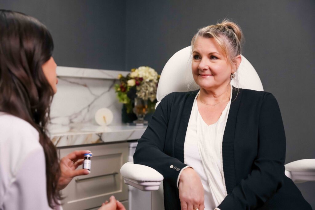 A mature female patient listens intently as a provider explains how Semaglutide, a GLP-1 receptor agonist, works for weight loss treatment in Arcadia.