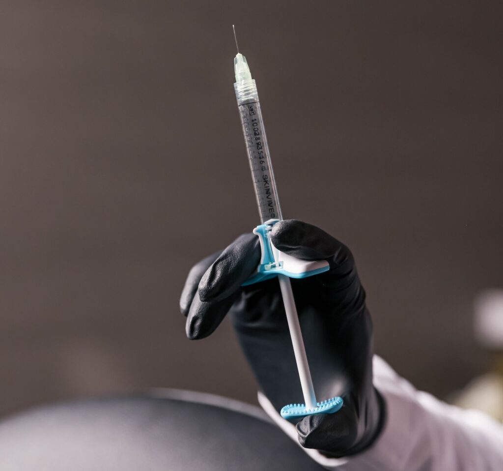 A provider holds a full syringe of Skinvive. We use this injectable as an alternative to, and support for, the best lip filler in Denver.